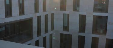 Sun setting over building corner